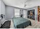 Bright bedroom with a ceiling fan, closet and wood-look luxury vinyl flooring at 10562 Lake Dr, Seminole, FL 33772