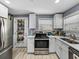 Efficient kitchen with stainless steel appliances, white cabinets, and smart storage solutions, maximizing both style and functionality at 10562 Lake Dr, Seminole, FL 33772