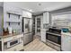 Bright and functional kitchen equipped with stainless steel appliances, white cabinets, and easy access to pantry items for convenience at 10562 Lake Dr, Seminole, FL 33772