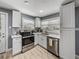Charming kitchen features stainless steel appliances, crisp white cabinetry, sleek countertops, and modern finishes for stylish cooking at 10562 Lake Dr, Seminole, FL 33772