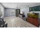 Inviting living room with wood-look flooring, neutral paint, bright windows, an aquarium, and ample space for comfortable living at 10562 Lake Dr, Seminole, FL 33772