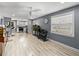 Spacious, neutral living space showcases natural light, a large aquarium, and an open transition to an adjacent modern kitchen at 10562 Lake Dr, Seminole, FL 33772