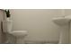 Simple, clean bathroom featuring a toilet and pedestal sink with neutral tones at 10824 Keato Beach Ct, Tampa, FL 33647