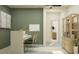 Bright home office featuring a modern desk, decorative accents, and open shelving, providing a stylish workspace at 10824 Keato Beach Ct, Tampa, FL 33647