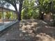 The backyard offers a screened-in porch and patio surrounded by mature trees creating a private outdoor oasis at 1106 Woodlawn Ave, Plant City, FL 33563