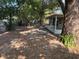 Expansive backyard with a screened-in porch and mature trees adding character to the outdoor space at 1106 Woodlawn Ave, Plant City, FL 33563