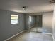 Bedroom featuring neutral walls, tile floors, window, and closet with mirrored doors at 1106 Woodlawn Ave, Plant City, FL 33563