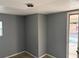 Bedroom with tiled floors, a window, grey painted walls, and access to a door at 1106 Woodlawn Ave, Plant City, FL 33563