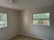 Bedroom featuring tiled floors, two windows, and neutral walls at 1106 Woodlawn Ave, Plant City, FL 33563