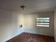 Bedroom featuring white walls, mosaic style patterned floors, and a window AC unit at 1106 Woodlawn Ave, Plant City, FL 33563