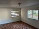 Bedroom featuring white walls, two windows, and a tile floor in a mosaic style pattern at 1106 Woodlawn Ave, Plant City, FL 33563