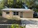 Charming single-story home with metal roof and ample front yard space at 1106 Woodlawn Ave, Plant City, FL 33563
