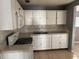 Practical kitchen area with white cabinets and essential appliances for cooking at 1106 Woodlawn Ave, Plant City, FL 33563