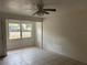 A modest Living Room with tiled floors and natural light streaming through the window at 1106 Woodlawn Ave, Plant City, FL 33563