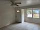 Bright living room featuring tiled floors, fan and a view from the front window at 1106 Woodlawn Ave, Plant City, FL 33563