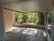 The screened-in porch provides an inviting outdoor space with views of the yard and mature landscaping at 1106 Woodlawn Ave, Plant City, FL 33563