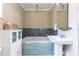 Bathroom with a soaking tub featuring decorative mosaic tiles, a stylish sink, and a vanity at 11210 Wheeling Dr, Tampa, FL 33625