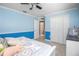 Cozy bedroom featuring calming blue walls, white trim, and a comfortable bed with decorative pillows and bedspread at 11210 Wheeling Dr, Tampa, FL 33625