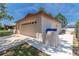 Garage exterior featuring a paved driveway, manicured lawn, and attached two car garage at 11210 Wheeling Dr, Tampa, FL 33625