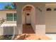 Beige home's front door and arched entry, showcasing a well-maintained exterior with window at 11210 Wheeling Dr, Tampa, FL 33625