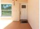 White front door with a window and a door mat, complemented by light beige exterior walls at 11210 Wheeling Dr, Tampa, FL 33625