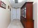 Hallway with tiled floor, decorative cabinet, and multiple doors at 11210 Wheeling Dr, Tampa, FL 33625