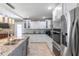 Modern kitchen with stainless steel appliances, an island, and bright white cabinetry at 11210 Wheeling Dr, Tampa, FL 33625