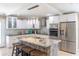 Modern kitchen with stainless steel appliances, island, and updated cabinets at 11210 Wheeling Dr, Tampa, FL 33625