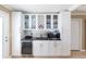 Stylish kitchen with granite countertops and stainless steel appliances, and glass cabinets at 11210 Wheeling Dr, Tampa, FL 33625
