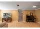 Cozy living room with ceramic tile floors, a TV, and a piano, perfect for relaxation at 11210 Wheeling Dr, Tampa, FL 33625