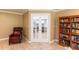 Inviting living room with tile flooring and french doors leading to the kitchen at 11210 Wheeling Dr, Tampa, FL 33625