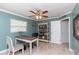 Inviting office with a ceiling fan, a desk, chair, and a bookshelf, perfect for remote work or study at 11210 Wheeling Dr, Tampa, FL 33625