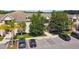 Aerial view shows condo buildings, assigned parking, and well-maintained landscaping at 1231 Godavari Way # 103, Wesley Chapel, FL 33543
