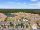 Community aerial view highlighting a scenic pond with a fountain and various neighborhood amenities at 1231 Godavari Way # 103, Wesley Chapel, FL 33543
