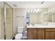 Bathroom featuring a single sink vanity and glass enclosed tiled shower, with wood-look floors at 1231 Godavari Way # 103, Wesley Chapel, FL 33543