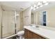 Bathroom with a glass enclosed shower, single sink vanity and a large mirror at 1231 Godavari Way # 103, Wesley Chapel, FL 33543