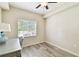 Cozy bedroom with tile floors, ceiling fan, and bright window at 1231 Godavari Way # 103, Wesley Chapel, FL 33543