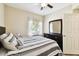 Bedroom featuring ceiling fan, dresser and mirror at 1231 Godavari Way # 103, Wesley Chapel, FL 33543