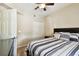 Bedroom featuring a bed, wood-look floors, and ensuite bathroom at 1231 Godavari Way # 103, Wesley Chapel, FL 33543