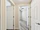View of bedroom with ceiling fan, grey wood-look tile, and white trim at 1231 Godavari Way # 103, Wesley Chapel, FL 33543