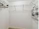 Walk-in closet with white wire shelving and ample storage space for clothes and accessories at 1231 Godavari Way # 103, Wesley Chapel, FL 33543