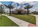 Beautiful community clubhouse with landscaping and sidewalk for easy access under a bright blue sky at 1231 Godavari Way # 103, Wesley Chapel, FL 33543
