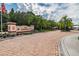 Beautiful gated entrance to the Anand Vihar community with palm trees and brick-paved road at 1231 Godavari Way # 103, Wesley Chapel, FL 33543