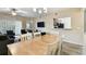 Open-concept dining area with modern lighting and bar access to the kitchen at 1231 Godavari Way # 103, Wesley Chapel, FL 33543