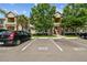 Condo exterior featuring landscaped front and parking with assigned spaces at 1231 Godavari Way # 103, Wesley Chapel, FL 33543