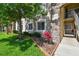 Close up exterior view of condo building with a green lawn and sidewalk at 1231 Godavari Way # 103, Wesley Chapel, FL 33543