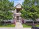 Exterior view of condo building featuring manicured landscaping and stone accents for a welcoming curb appeal at 1231 Godavari Way # 103, Wesley Chapel, FL 33543