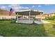 Charming gazebo adorned with flags, set in a beautifully landscaped community common area at 1231 Godavari Way # 103, Wesley Chapel, FL 33543