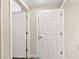 Hallway with white doors and trim, and grey wood-look tile at 1231 Godavari Way # 103, Wesley Chapel, FL 33543