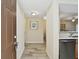 Inviting hallway with wood-look tile flooring, leading to the kitchen and dining area at 1231 Godavari Way # 103, Wesley Chapel, FL 33543
